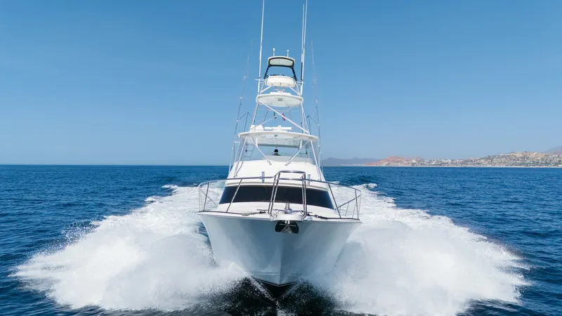 Slide: The Image of 2009 Viking 50 Convertible "Jammin" - Bow View in Motion This dynamic image showcases the commanding bow of the 2009 Viking 50 Convertible, cutting through the waves with precision. The sleek design emphasizes its powerful performance and stability on the open water. The vessel's tower and clean lines highlight - 7018221
