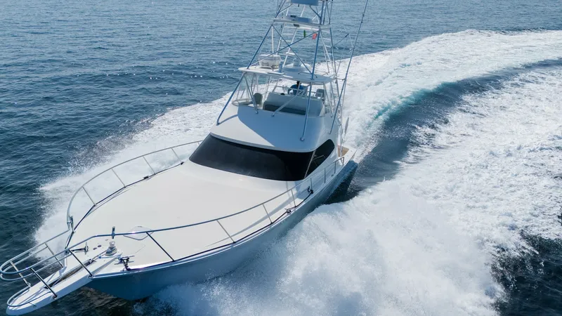 Slide: The Image of 2009 Viking 50 Convertible "Jammin" This dynamic image showcases the sleek bow of the 2009 Viking 50 Convertible 'Jammin' slicing through the waves. The vessel's robust tower, ideal for spotting fish or enjoying panoramic ocean views, rises prominently above the deck. The clean lines and st - 7018222
