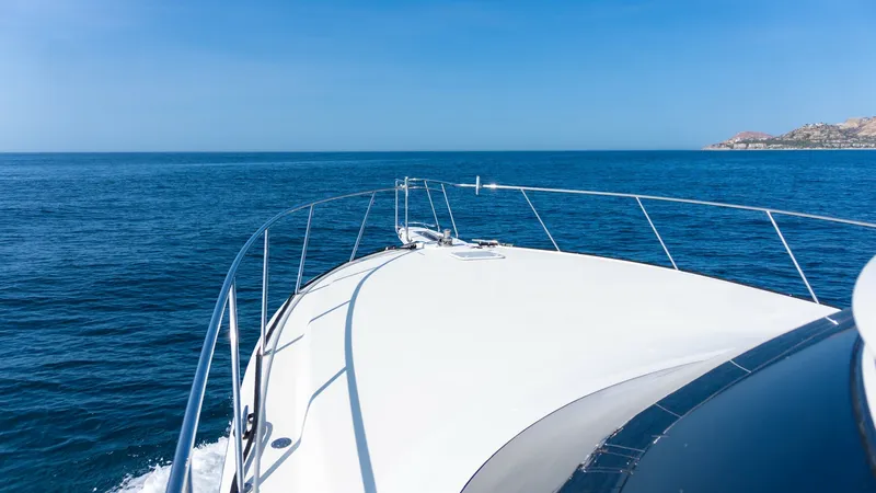 Slide: The Image of 2009 Viking 50 Convertible "Jammin" - Spacious Foredeck The bow of the 2009 Viking 50 Convertible, 'Jammin', is seen slicing through the azure waters, showcasing its sleek and powerful design. The stainless steel railings provide both safety and style, while the expansive deck offers unobstructed views of the - 7018180