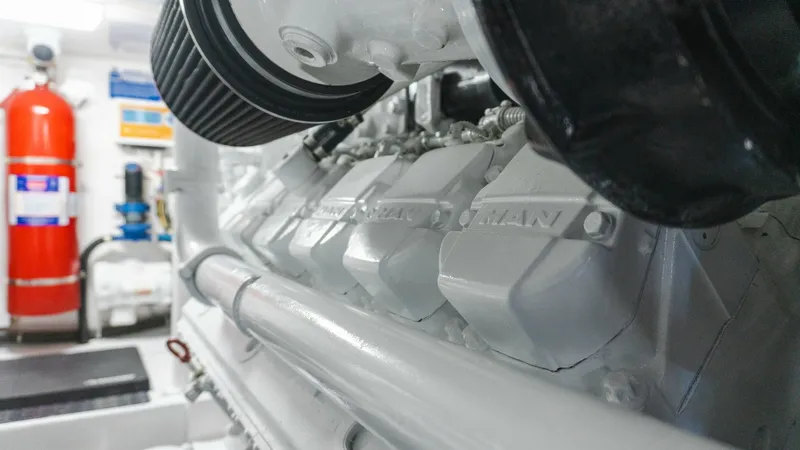 Slide: The Image of 2009 Viking 50 Convertible "Jammin" - Engine Room with MAN Engines This image showcases the powerful MAN engines in the engine room of the 2009 Viking 50 Convertible, Jammin. The pristine white finish and robust construction highlight the vessel's commitment to performance and reliability. The well-organized layout ensur - 7018215