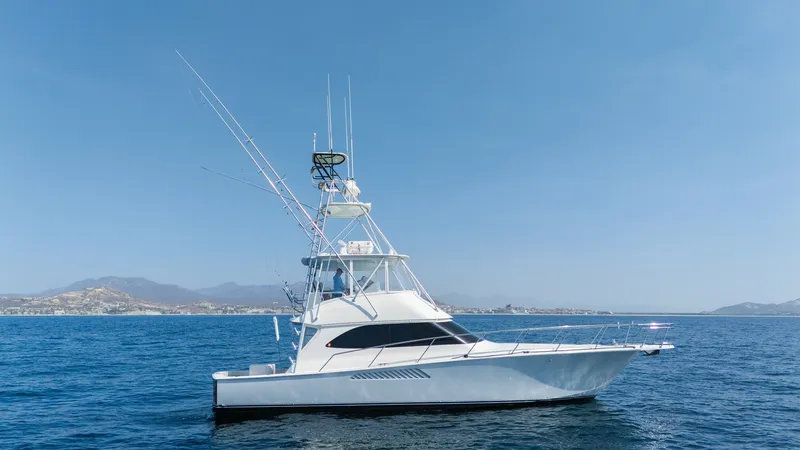 The Image of 2009 Viking 50 Convertible "Jammin" - Engineered to Lead This image showcases the sleek side profile of the 2009 Viking 50 Convertible 'Jammin', emphasizing its streamlined hull and elegant lines. The vessel's flybridge is equipped with advanced fishing towers, enhancing its sportfishing capabilities. The open - 7018168
