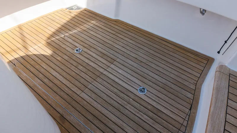 Slide: The Image of 2009 Viking 50 Convertible "Jammin" - Teak Cockpit Decking The image showcases the elegant teak decking of the cockpit area on the 2009 Viking 50 Convertible, Jammin. The rich, natural wood finish provides both durability and a classic aesthetic appeal. This spacious area is ideal for fishing or relaxing, with ea - 7018206