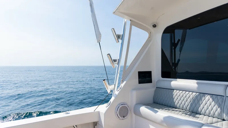 Slide: The Image of 2009 Viking 50 Convertible "Jammin" - Aft Deck Seating Area The aft deck of the 2009 Viking 50 Convertible features a comfortable seating area with plush, diamond-stitched upholstery. This space is ideal for relaxing while enjoying panoramic ocean views, enhanced by the sleek lines and modern design. The area is e - 7018209