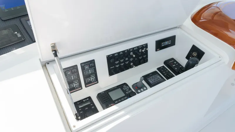 Slide: The Image of 2009 Viking 50 Convertible "Jammin" - Helm Control Panel and Electronics This image showcases the helm control panel of the 2009 Viking 50 Convertible. The panel is equipped with advanced navigation and communication electronics, neatly arranged for easy access and operation. The high-quality finish and ergonomic layout enhanc - 7018188