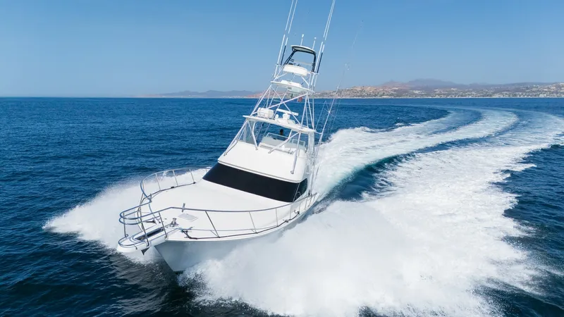 Slide: The Image of 2009 Viking 50 Convertible "Jammin" - Dynamic Forward Bow View This image showcases the Viking 50 Convertible slicing through the water with impressive agility. The sleek, aerodynamic bow and robust railing are designed for superior performance and safety. The flybridge offers panoramic visibility, emphasizing the ya - 7018223