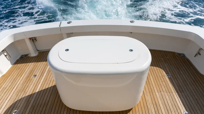 Slide: The Image of 2009 Viking 50 Convertible "Jammin" - The cockpit of the 2009 Viking 50 Convertible, 'Jammin', features elegant teak decking and a central Livewell station. This area is designed for both leisure and functionality, providing ample space for activities and easy access to the sea. The sleek lin - 7018207