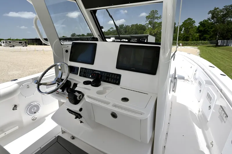 Slide: The Image of The Helm Twin Garmin displays, Yamaha binnacle, joystick, and destroyer wheel. - 6788450