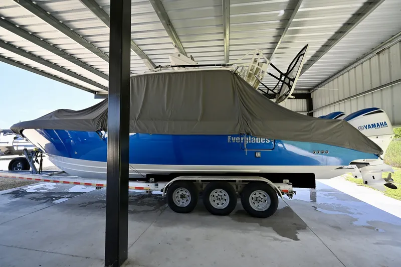 Slide: The Image of  Stored Under Cover 355 CC under a covered slip with full boat cover, folded tower, triple F300s. - 6788467