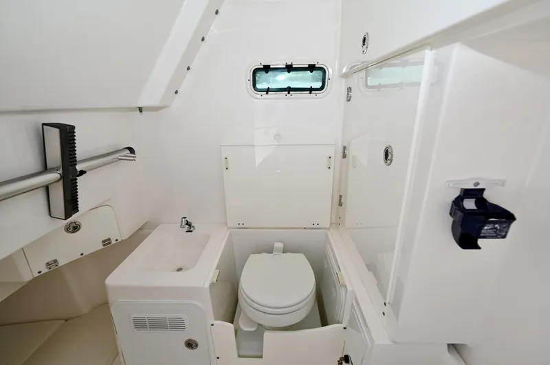 Slide: The Image of Console Head Compartment Dometic marine head, sink, rod storage, and opening port with standing room. - 6788464