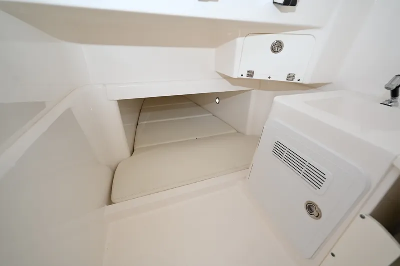 Slide: The Image of Console Berth Padded berth inside the console with courtesy lighting and overhead storage - 6788463