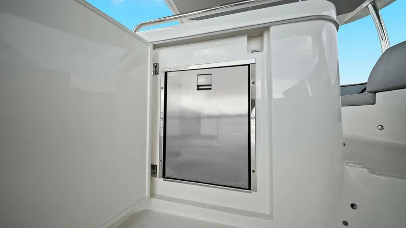 Slide: The Image of Galley Storage with Stainless Steel Door This image showcases a sleek galley storage area on the Absolute 52 Navetta, featuring a modern stainless steel door. The polished finish adds a touch of elegance, while the surrounding cabinetry provides ample storage space. The design emphasizes functio - 6851783
