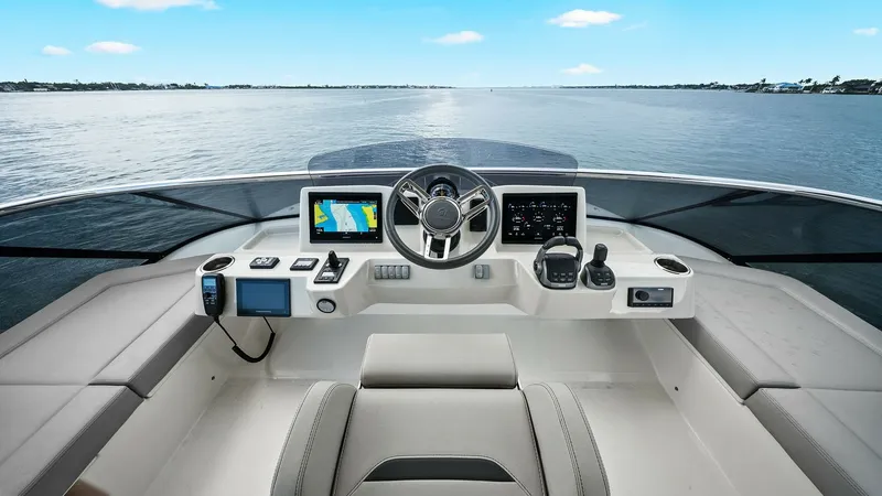 Slide: The Image of Flybridge Helm Station View The helm station on the flybridge of the 2024 Absolute 52 Navetta offers a commanding view of the surrounding waters. This space features state-of-the-art navigation equipment, including dual multifunction displays and ergonomic controls, ensuring ease an - 6851773
