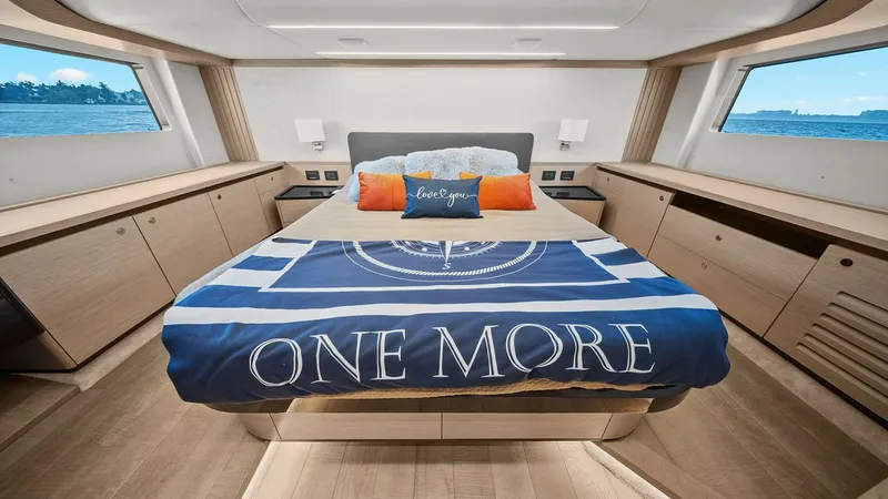 Slide: The Image of Master Stateroom with Panoramic Views The master stateroom aboard the 2024 Absolute 52 Navetta exudes luxury and comfort. Featuring expansive windows that offer breathtaking panoramic views, this space is adorned with elegant wood finishes and ambient lighting. The central queen-sized bed is - 6851768