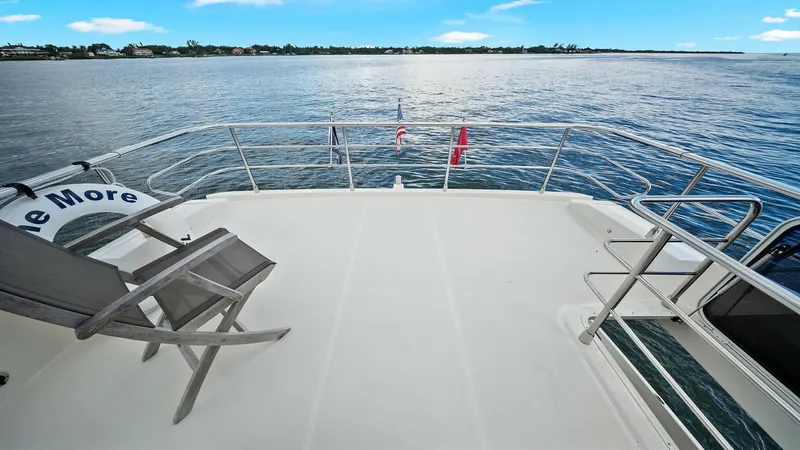 Slide: The Image of Spacious Aft Deck with Ocean View The aft deck of the 2024 Absolute 52 Navetta offers a serene setting with expansive ocean views. Featuring a clean, open layout, it provides ample space for relaxation or entertaining. The elegant railing enhances safety while offering unobstructed vistas - 6851789