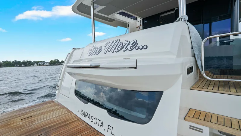 Slide: The Image of Stern View with Teak Swim Platform This image showcases the elegant stern of the 2024 Absolute 52 Navetta, 'One More'. The teak swim platform provides a luxurious and practical space for water activities, complemented by the vessel's sleek design. The polished stainless steel accents and c - 6851871