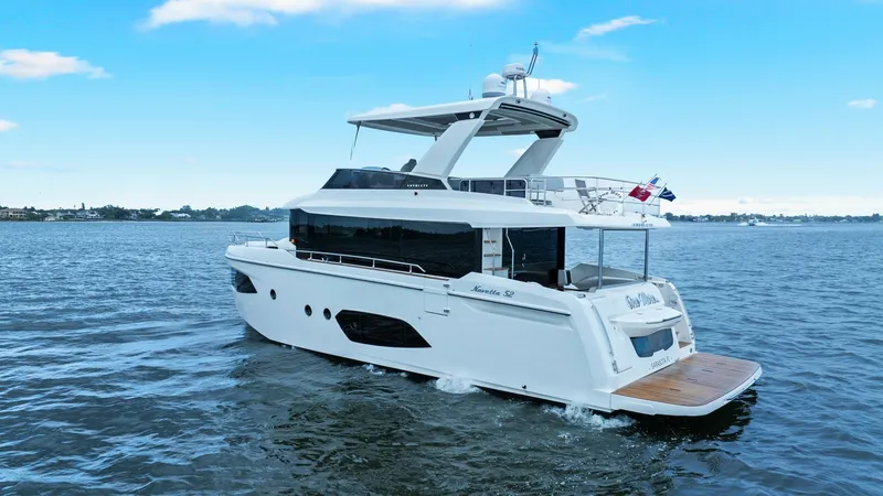 Slide: The Image of Aft Deck and Exterior View This image showcases the elegant aft deck and exterior of the 2024 Absolute 52 Navetta, named 'One More'. The spacious aft deck features a teak swim platform, perfect for easy water access. The sleek design is complemented by expansive windows, providing - 6851851