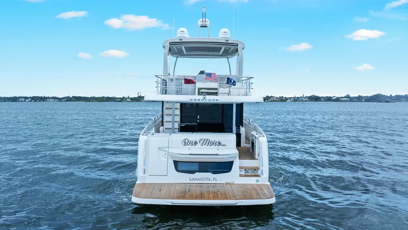 Slide: The Image of Stern View with Extended Swim Platform The 2024 Absolute 52 Navetta 'One More' showcases a spacious stern with an inviting teak swim platform. The design highlights seamless access to the water and features elegant railings for safety. This area offers a perfect blend of style and functionalit - 6851868