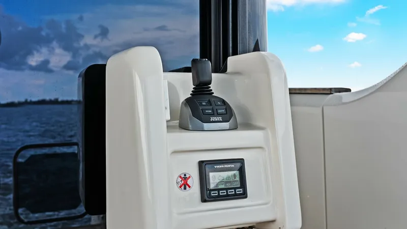 Slide: The Image of Joystick Control Station This image showcases the sleek joystick control station on the Absolute 52 Navetta. The ergonomic design offers intuitive handling, enhancing the vessel's maneuverability. Set against a backdrop of serene waters, this feature highlights advanced technolog - 6851796