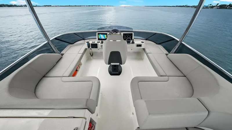 Slide: The Image of Flybridge Helm and Seating Area This elegant flybridge on the 2024 Absolute 52 Navetta features a central helm station equipped with modern navigation instruments. Surrounding the helm is a spacious seating area with plush, cushioned benches, offering a comfortable space for relaxation - 6851772