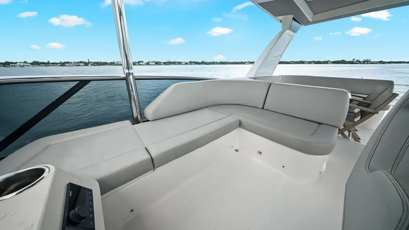 Slide: The Image of Spacious Aft Deck Lounge Area The aft deck of the 2024 Absolute 52 Navetta, 'One More', features a luxurious L-shaped seating area, perfect for relaxation and socializing. The sleek, modern design is complemented by high-quality materials and finishes, offering both comfort and style. - 6851779