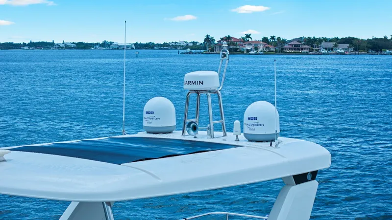 Slide: The Image of Flybridge Electronics and Antennas The flybridge of the 2024 Absolute 52 Navetta showcases advanced navigation and communication technology, featuring Garmin and KVH antennas for seamless connectivity. The sleek design integrates these systems into the modern aesthetic of the vessel, ensur - 6851855