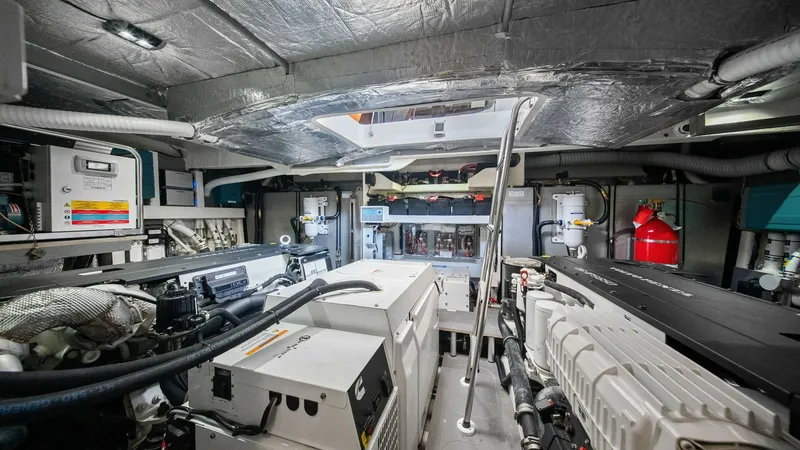 Slide: The Image of Engine Room with Twin Engines The engine room of the 2024 Absolute 52 Navetta showcases a meticulously organized space with twin engines, ensuring optimal performance and efficiency. The room is well-lit and features advanced insulation for noise reduction. High-quality components and - 6851847
