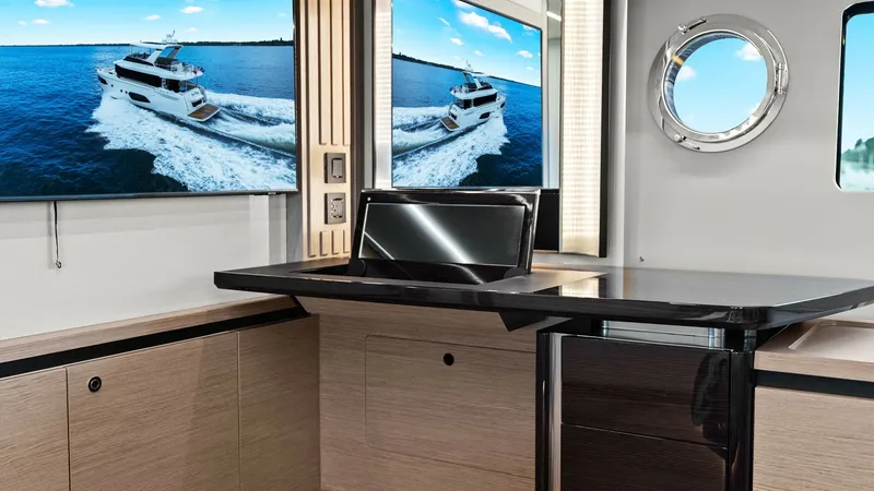 Slide: The Image of Stylish Interior Office Space This elegant interior space aboard the 2024 Absolute 52 Navetta features a sleek, modern desk area with high-gloss finishes and light wood cabinetry. The large window and porthole provide ample natural light, enhancing the room's airy ambiance. A wall-mou - 6851819