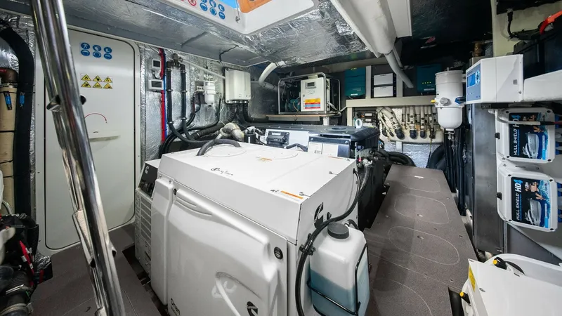 Slide: The Image of Engine Room with Generator The engine room of the 2024 Absolute 52 Navetta showcases a well-organized space featuring a prominent generator for efficient power management. High-quality insulation and neatly arranged systems ensure reliable performance and easy maintenance. This are - 6851842