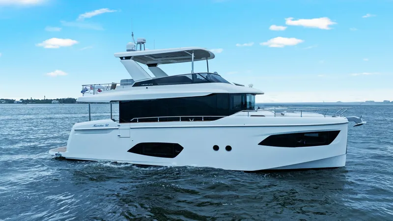 Slide: The Image of Starboard Profile View of 52 Navetta This image showcases the sleek starboard profile of the 2024 Absolute 52 Navetta. The vessel features a modern design with expansive windows for panoramic views and abundant natural light. The distinctive lines and robust structure ensure both elegance an - 6851849