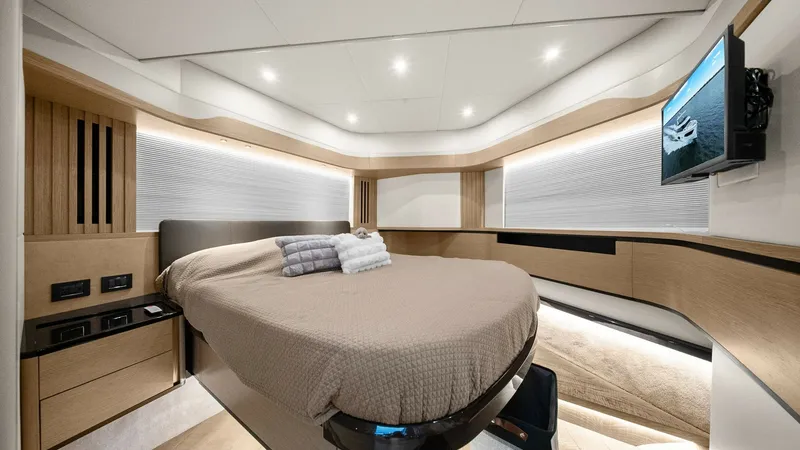 Slide: The Image of Forward Stateroom with Modern Amenities The forward stateroom of the 2024 Absolute 52 Navetta exudes modern elegance with its sleek design and luxurious finishes. The centrally positioned bed is complemented by soft ambient lighting, enhancing the room's cozy and inviting atmosphere. Ample stor - 6851815