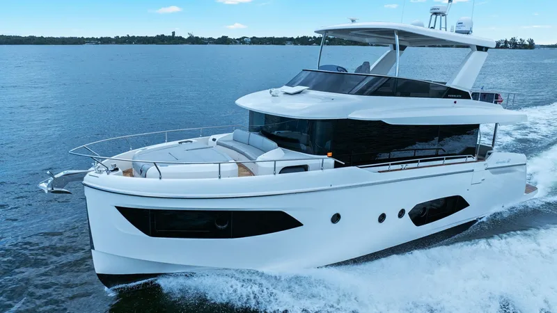 Slide: The Image of Dynamic Side View Underway The Absolute 52 Navetta, 'One More', glides through the water with elegance in this dynamic side view. The sleek, modern lines of the 2024 model are complemented by expansive windows, allowing natural light to flood the interior. The upper deck provides a - 6851865
