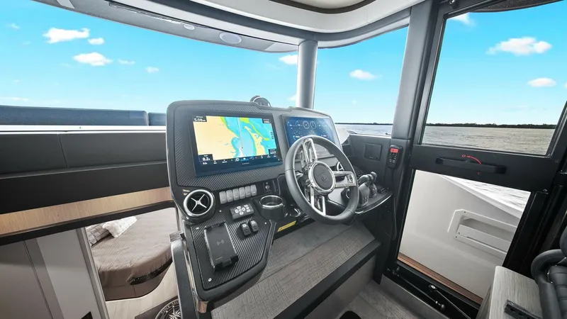 Slide: The Image of Helm Station with Modern Electronics The helm station of the 2024 Absolute 52 Navetta offers state-of-the-art navigation systems and a sleek, ergonomic design. Featuring dual multifunction displays and a precision steering wheel, the console ensures effortless control and navigation. Expansi - 6851814