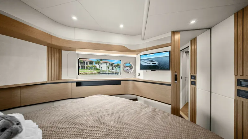 Slide: The Image of Luxurious Forward Stateroom The forward stateroom of the 2024 Absolute 52 Navetta offers a blend of elegance and comfort. Featuring a spacious bed with plush bedding, the room is designed with warm wood accents and soft ambient lighting. Large windows provide stunning views, enhanci - 6851817