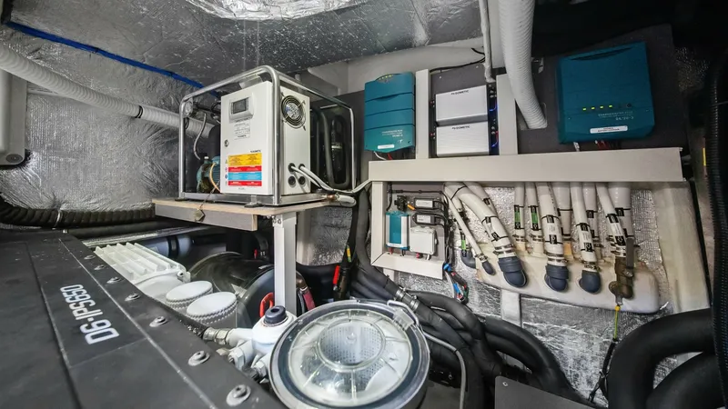 Slide: The Image of Engine Room with Advanced Systems The engine room of the 2024 Absolute 52 Navetta showcases a meticulously organized layout featuring state-of-the-art machinery and systems. Prominent components include a D6 IPS650 engine and modern control panels, ensuring optimal performance and efficie - 6851844