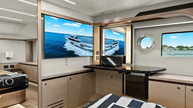 Slide: The Image of Master Stateroom with Panoramic Views This elegant master stateroom aboard the 2024 Absolute 52 Navetta offers a luxurious retreat with stunning panoramic views. The room features a sleek, contemporary design with high-end finishes and ample natural light from a large porthole and additional - 6851828