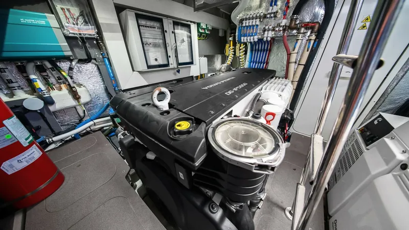 Slide: The Image of Engine Room with Modern Systems This image showcases the advanced engine room of the Absolute 52 Navetta, featuring state-of-the-art engineering and efficient layout. The space is equipped with a robust engine, clearly organized control panels, and high-quality piping systems, ensuring - 6851840