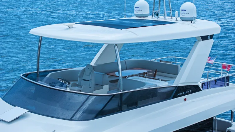 Slide: The Image of Flybridge with Helm and Seating Area The flybridge of the Absolute 52 Navetta offers a spacious and luxurious seating area, perfect for entertaining and enjoying panoramic views. Equipped with a sleek helm station, this area combines functionality with style, featuring high-quality materials - 6851854