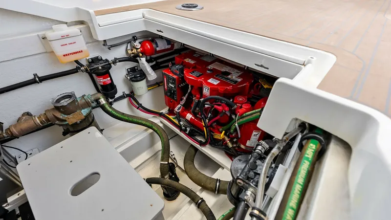 Slide: The Image of Engine Compartment with Systems Access This image showcases the well-organized engine compartment of the 2025 MJM M3, featuring neatly arranged wiring and accessible systems. The compartment is designed for easy maintenance, with clearly labeled components and high-quality materials ensuring r - 6834933