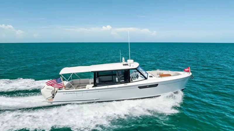 Slide: The Image of Starboard Profile Cruising View The Sunshine Crew, a 2025 MJM M3, glides effortlessly across the open water, showcasing its sleek, modern lines. The starboard profile highlights the expansive cabin windows and the spacious aft deck, perfect for lounging. Its elegant design and powerful - 6834952