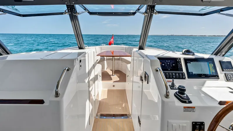 Slide: The Image of Helm and Forward Cockpit View The helm of the MJM M3, The Sunshine Crew, offers a modern and efficient layout with state-of-the-art navigation systems and controls, ensuring easy operation and safety. The forward cockpit is bathed in natural light, thanks to panoramic windows, providi - 6834908