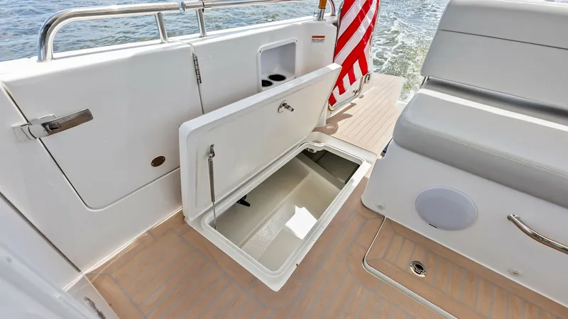 Slide: The Image of Aft Deck Storage Compartment This image showcases the aft deck storage compartment of the 2025 MJM M3, designed for efficient use of space. The compartment is seamlessly integrated into the deck, offering ample storage for gear and essentials. The elegant teak flooring complements th - 6834936