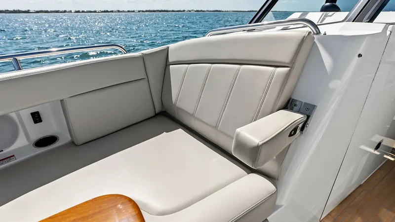 Slide: The Image of Aft Deck Seating Area This inviting aft deck seating area of the 2025 MJM M3 features plush, light-colored upholstery that complements the vessel's sleek design. The ergonomic layout includes a comfortable armrest and a convenient wooden table, perfect for socializing or enjoy - 6834912