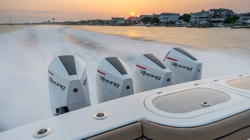 Slide: The Image of Quad Outboard Engines at Sunset The MarMar V-46 showcases four powerful outboard engines, capturing the essence of speed and performance as it cuts through the water. The sleek design of the engines is complemented by the warm glow of the sunset, highlighting the vessel's capability and - 7162327