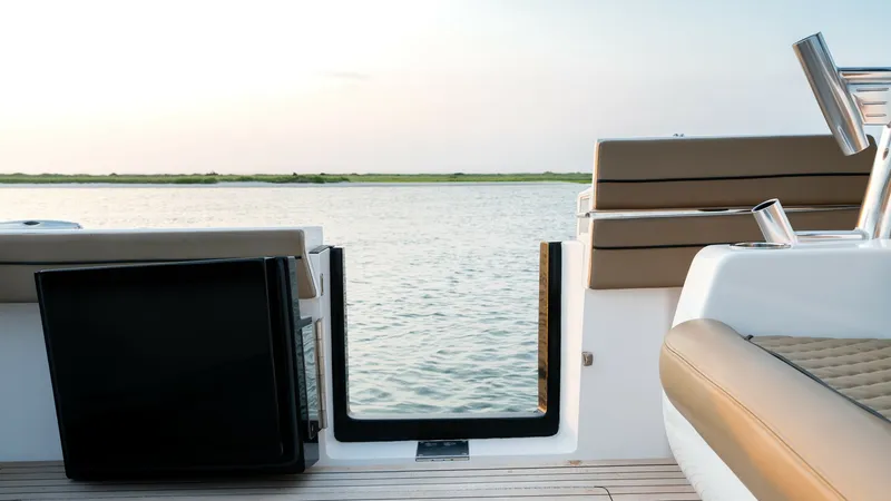 Slide: The Image of Aft Deck with Swim Platform Access This image showcases the aft deck of the 2022 Valhalla Boatworks V-46, featuring elegant teak flooring and comfortable seating. The open access to the swim platform provides an inviting connection to the water, perfect for leisurely activities. The area i - 7162295