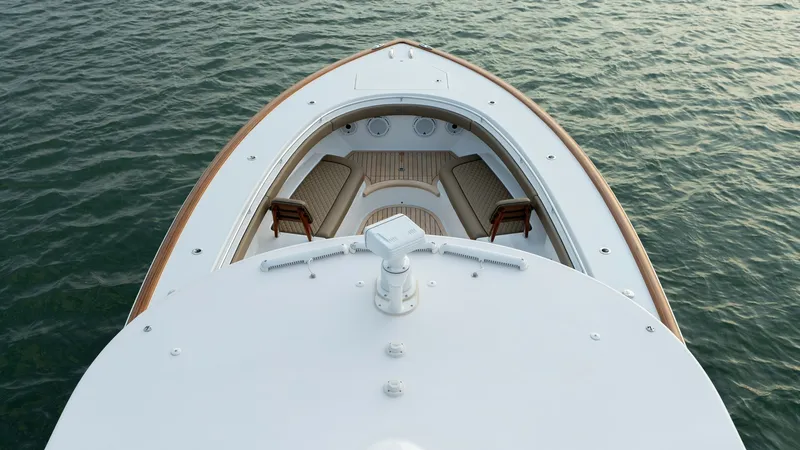 Slide: The Image of Bow Seating Area with Cushions The bow of the V-46 by Valhalla Boatworks showcases a beautifully designed seating area with plush, cream-colored cushions. The teak accents add a touch of elegance, complementing the sleek, modern lines of the vessel. This inviting space is perfect for r - 7162304