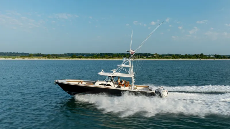 Slide: The Image of Side View of Valhalla V-46 Cruising The Valhalla V-46, crafted by Valhalla Boatworks in 2022, is showcased cruising smoothly over open waters. Its sleek hull design and powerful outboard engines ensure a swift and stable ride, ideal for both leisurely trips and competitive fishing. The spac - 7162337