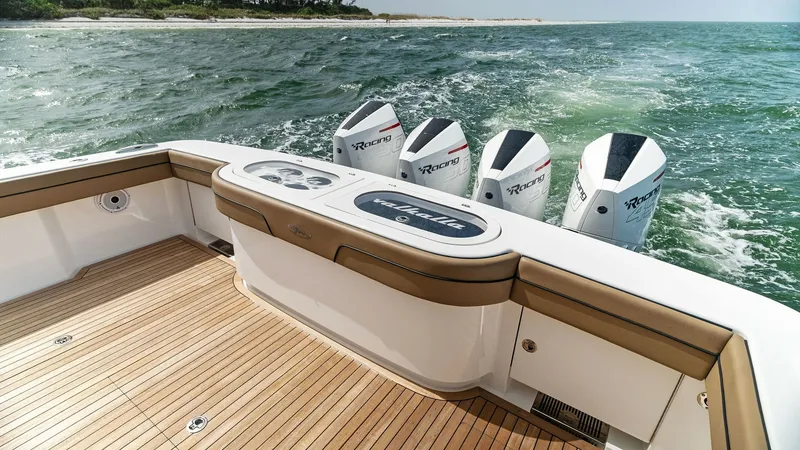 Slide: The Image of Aft Deck with Quad Engines This image showcases the sleek aft deck of the MarMar V-46, featuring a spacious area with high-quality teak flooring. The deck is equipped with four powerful outboard engines, promising exceptional performance and speed. The elegant design is complemente - 6845072