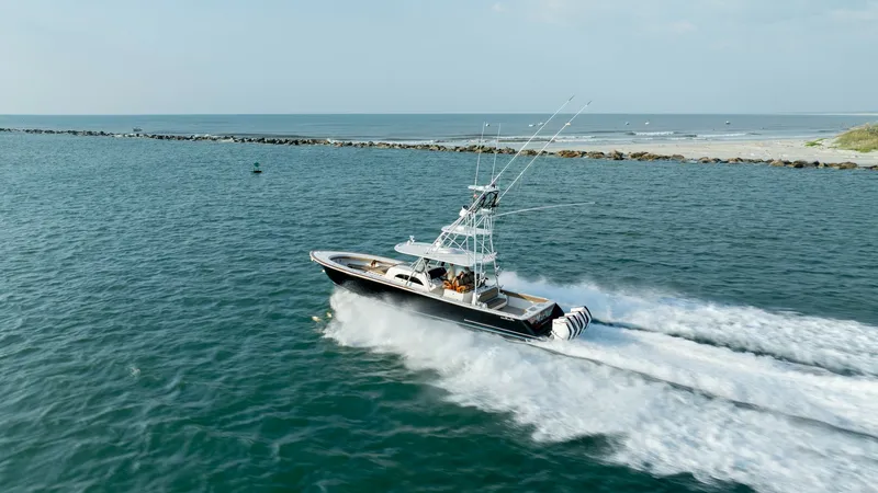 Slide: The Image of Valhalla V-46 in Full Throttle The Valhalla V-46, crafted by Valhalla Boatworks in 2022, is showcased slicing through the waves with remarkable power and speed. This vessel exemplifies superior performance with its sleek hull design and robust outboard engines, perfect for offshore adv - 7162338