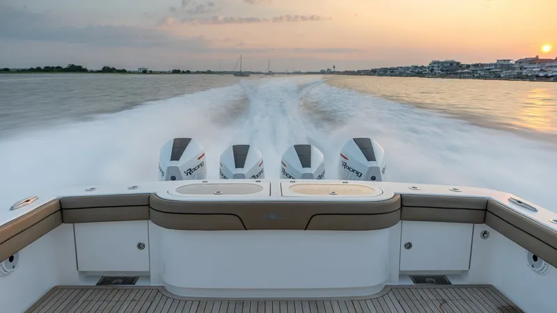 Slide: The Image of Aft Deck with Quad Outboards The aft deck of the 2022 Valhalla Boatworks V-46 showcases a spacious layout with plush seating and advanced quad outboard engines. The teak flooring adds a touch of elegance, while the clean lines and ample storage ensure a functional space. This area is - 7162280