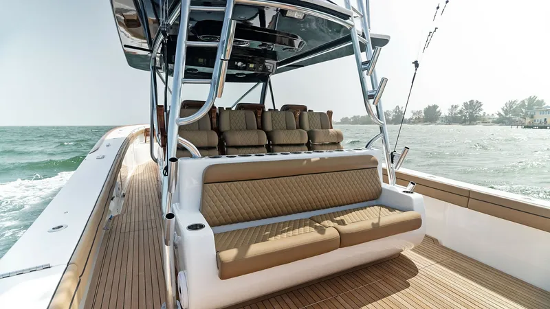 Slide: The Image of Spacious Aft Deck Seating Area The aft deck of the 2022 Valhalla V-46 features luxurious, cushioned bench seating, providing ample comfort for passengers. The teak decking complements the sleek design and enhances the vessel's elegance. With its open layout and durable construction, th - 6845069